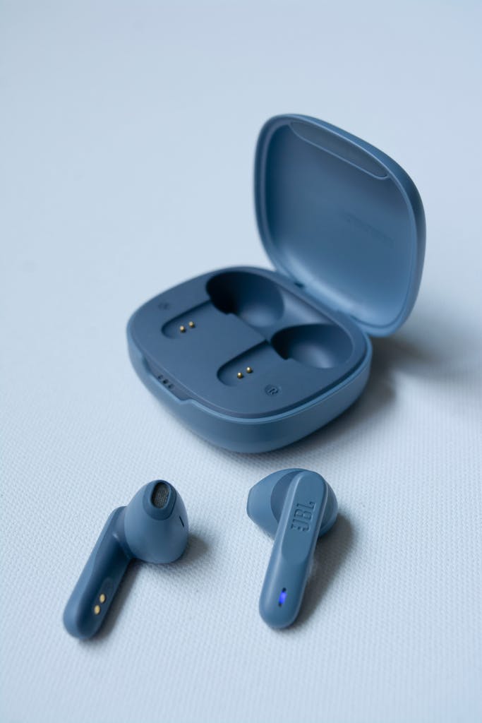 Close-up of sleek wireless earbuds with an open charging case on a white background.